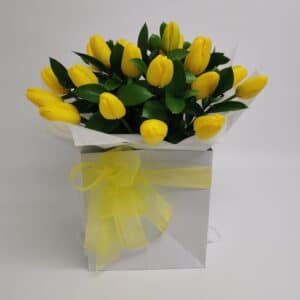 box of yellow tulips with yellow strapping in a white box