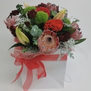 assorted flower bouquet with red tones and strapping