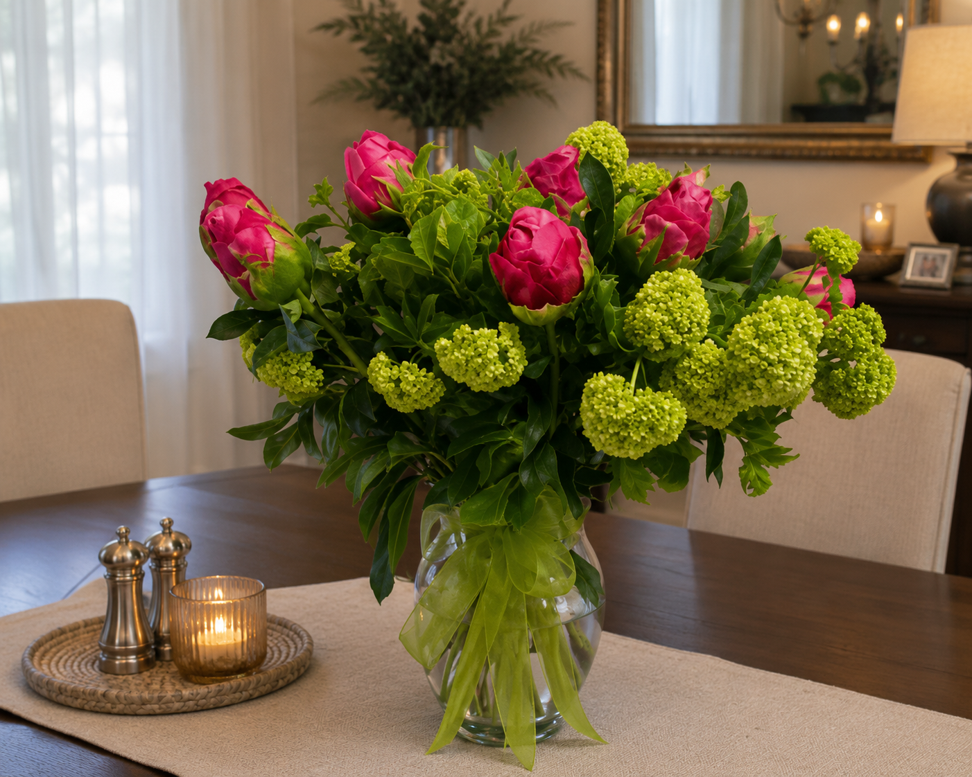pink peonies in glass vase in setting