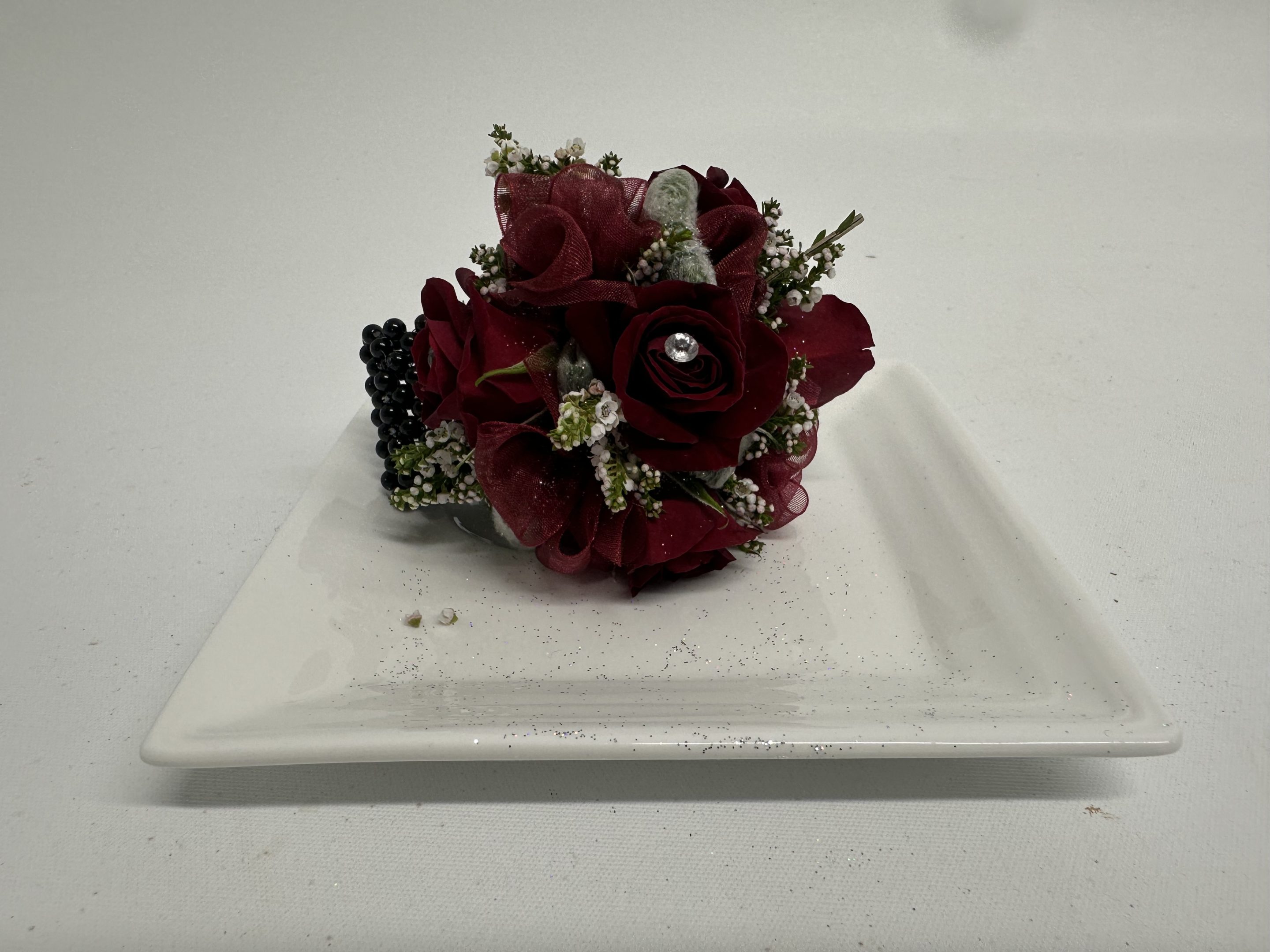 Burdundy classic Corsage on plate