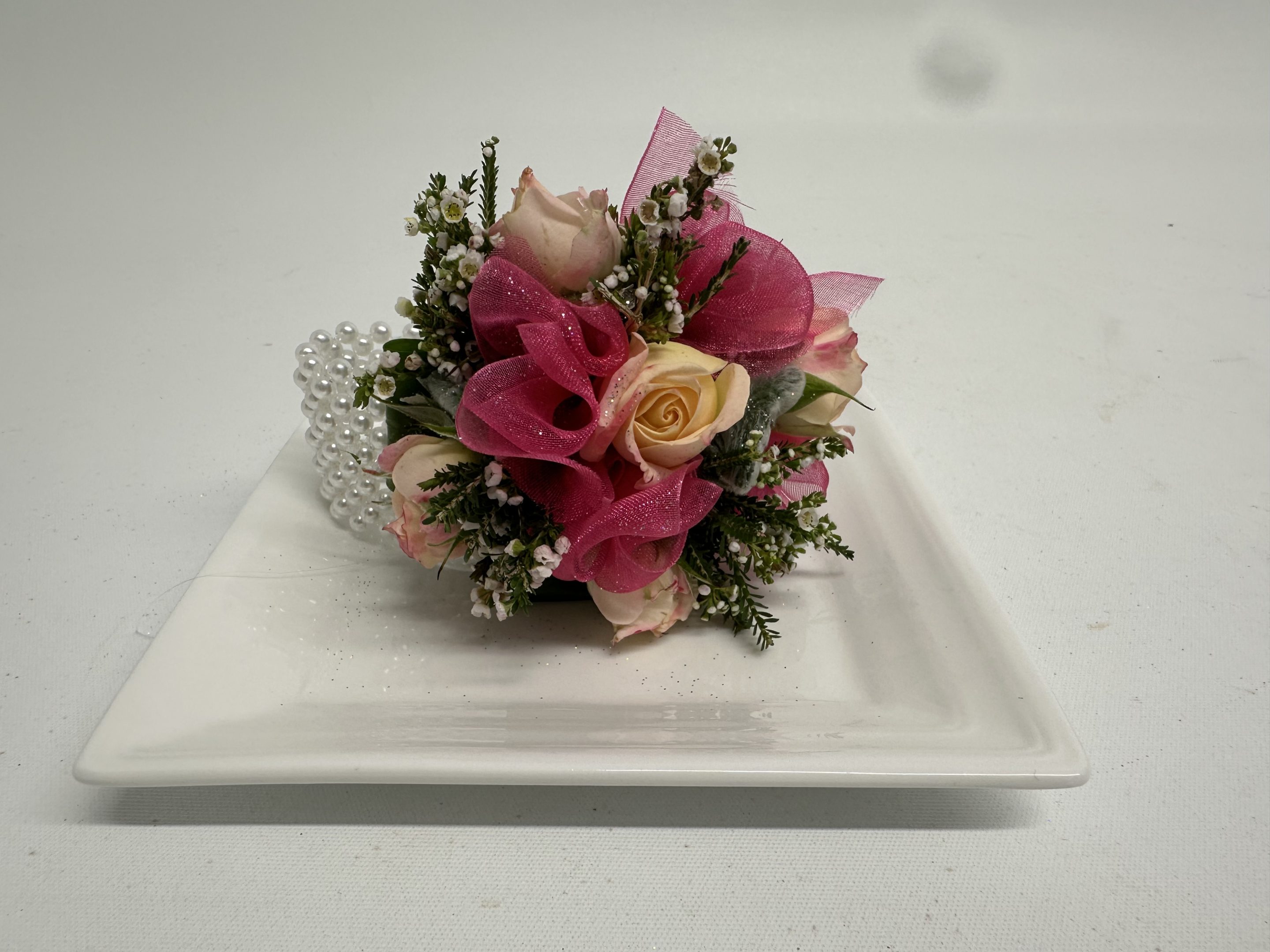 hot pink corsage on plate