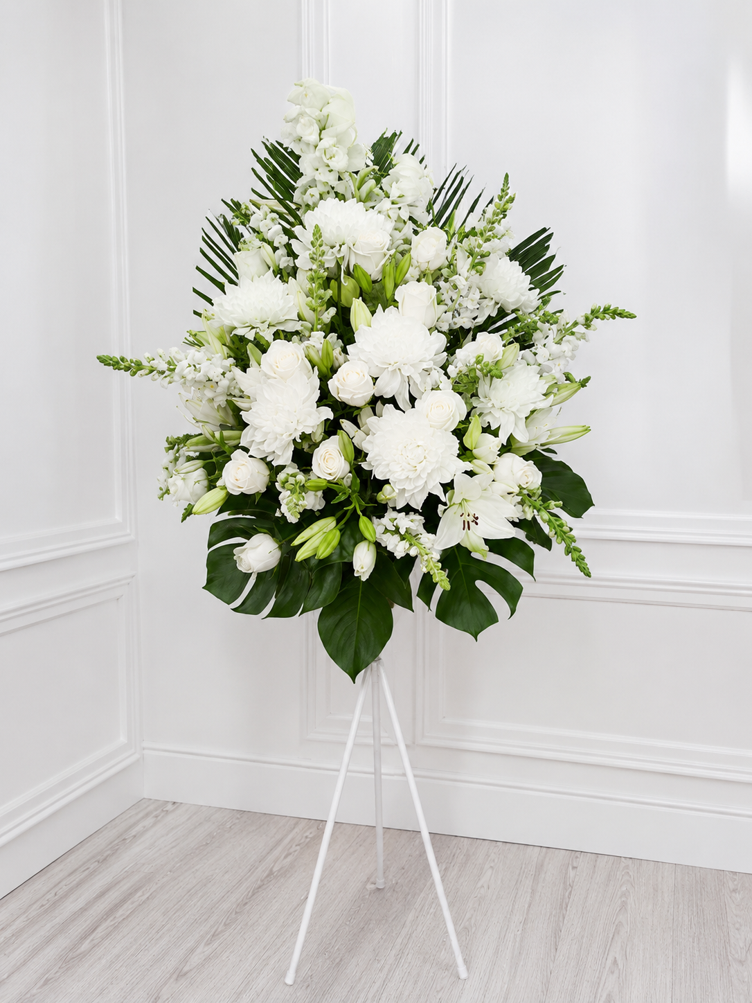 white sympathy arrangement on stand