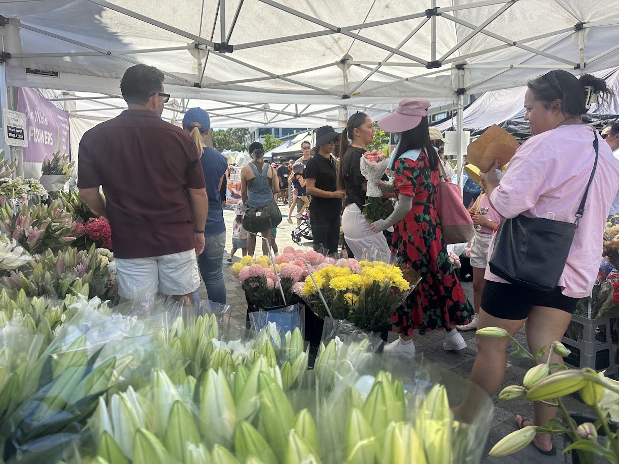 Customers choosing flowers at the Jan Maree Flowers market stall